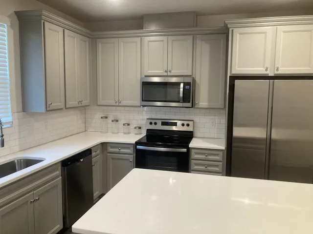 a kitchen with a refrigerator stove and sink