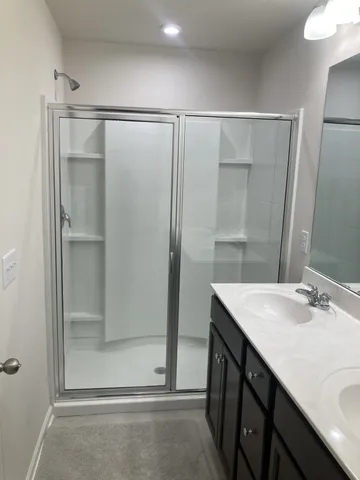 a bathroom with a sink and shower