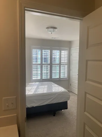 a spacious bedroom with a bed and a window