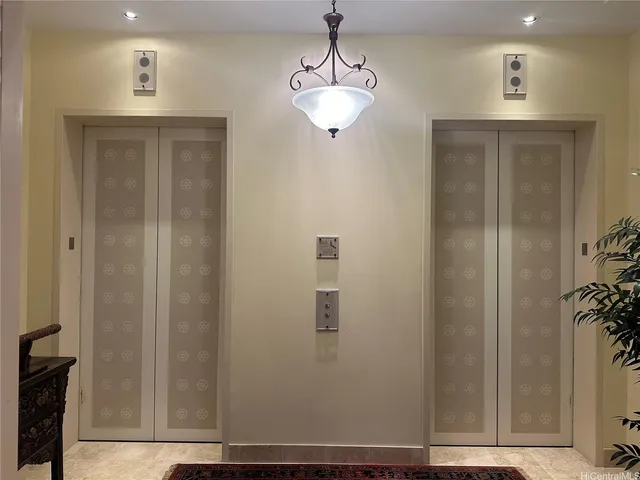 a view of a hallway with closet and front door