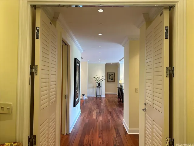 a view of a hallway with wooden floor