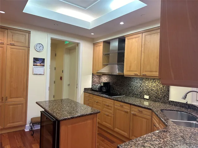 a kitchen with stainless steel appliances granite countertop a sink stove and cabinets