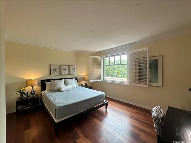 a bedroom with a bed and wooden floor