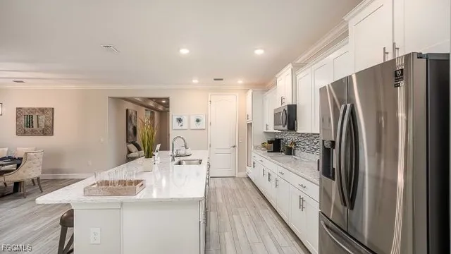 a kitchen with stainless steel appliances a refrigerator and a stove