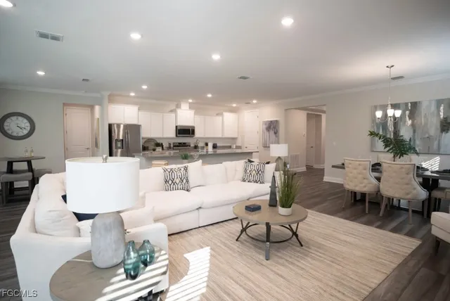 a living room with lots of furniture and kitchen view