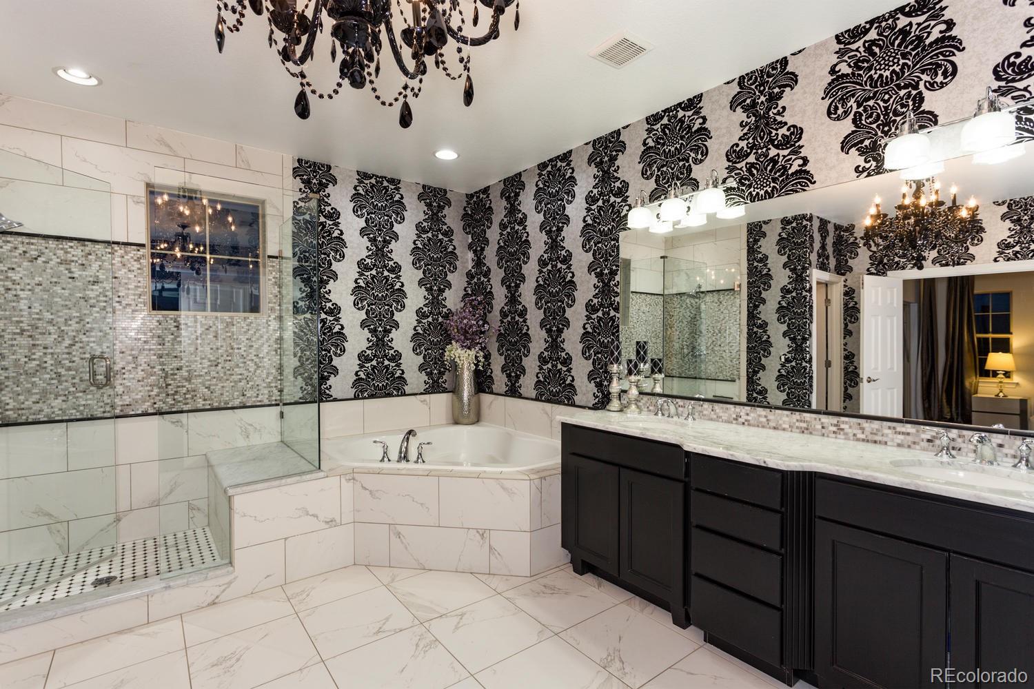 10808 Sundial Rim Road Highlands Ranch, CO 80126 - Photo 12 of 26 a bathroom with a double vanity sink mirror and bathtub