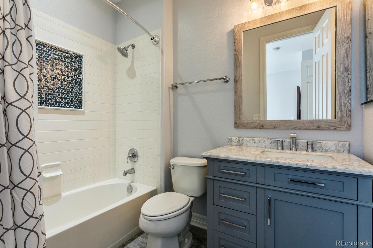 10808 Sundial Rim Road Highlands Ranch, CO 80126 - Photo 14 of 26 a bathroom with a toilet sink and mirror