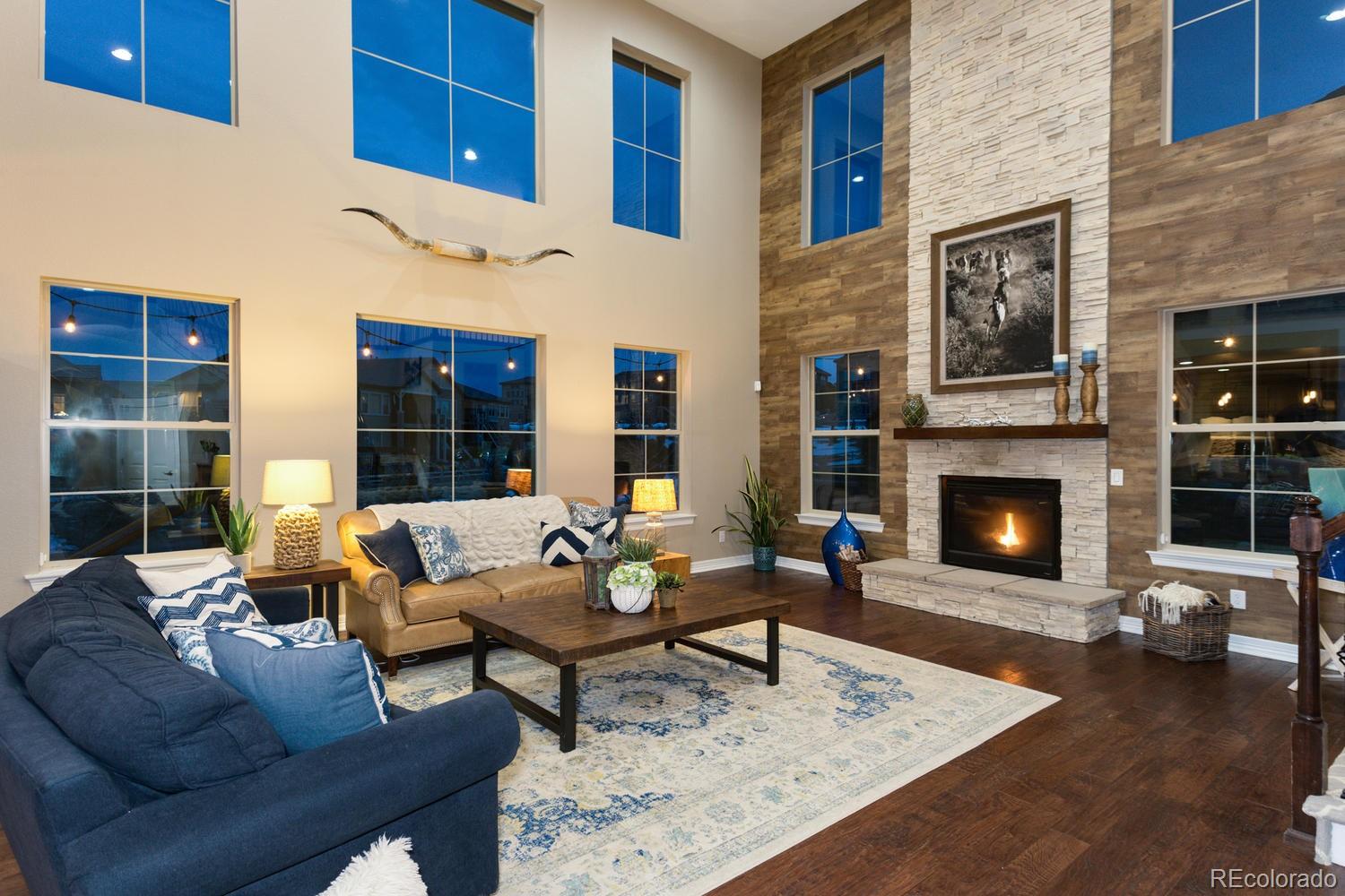 10808 Sundial Rim Road Highlands Ranch, CO 80126 - Photo 21 of 26 a living room with furniture and a fireplace