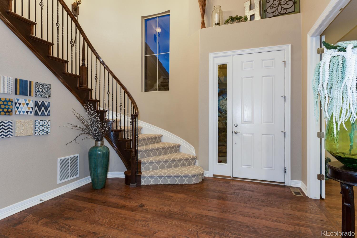 10808 Sundial Rim Road Highlands Ranch, CO 80126 - Photo 22 of 26 a view of entryway and hall with wooden floor