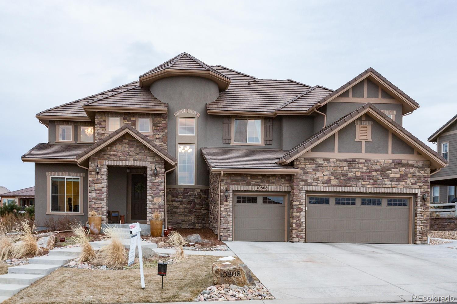10808 Sundial Rim Road Highlands Ranch, CO 80126 - Photo 26 of 26 a front view of a house with yard