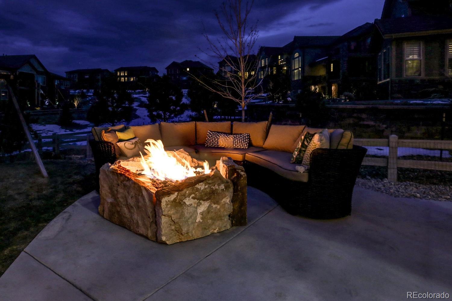 10808 Sundial Rim Road Highlands Ranch, CO 80126 - Photo 3 of 26 a outdoor living space with furniture and a fireplace