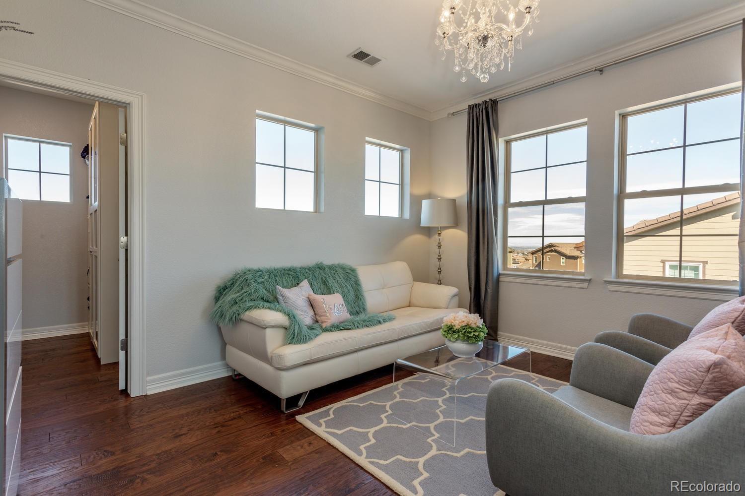 10808 Sundial Rim Road Highlands Ranch, CO 80126 - Photo 10 of 26 a living room with furniture and a large window