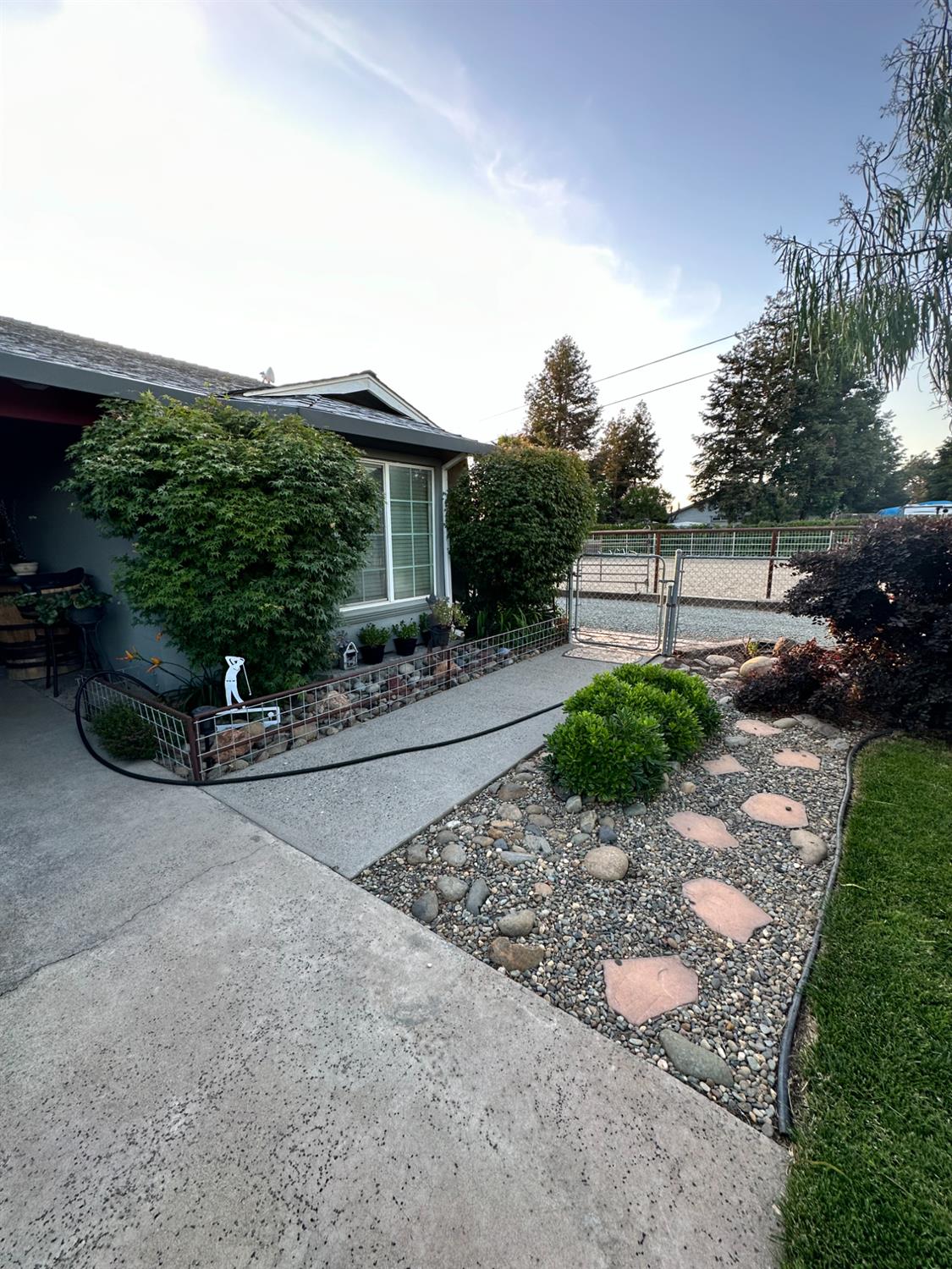 955 Elma Street Hickman, CA 95323 - Photo 2 of 27 a front view of a house with a yard
