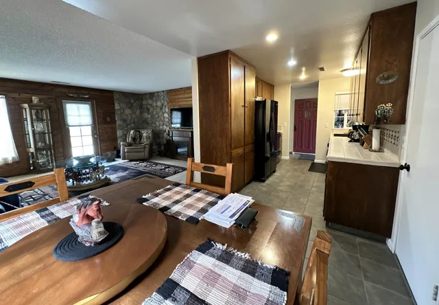 a living room with furniture and kitchen view