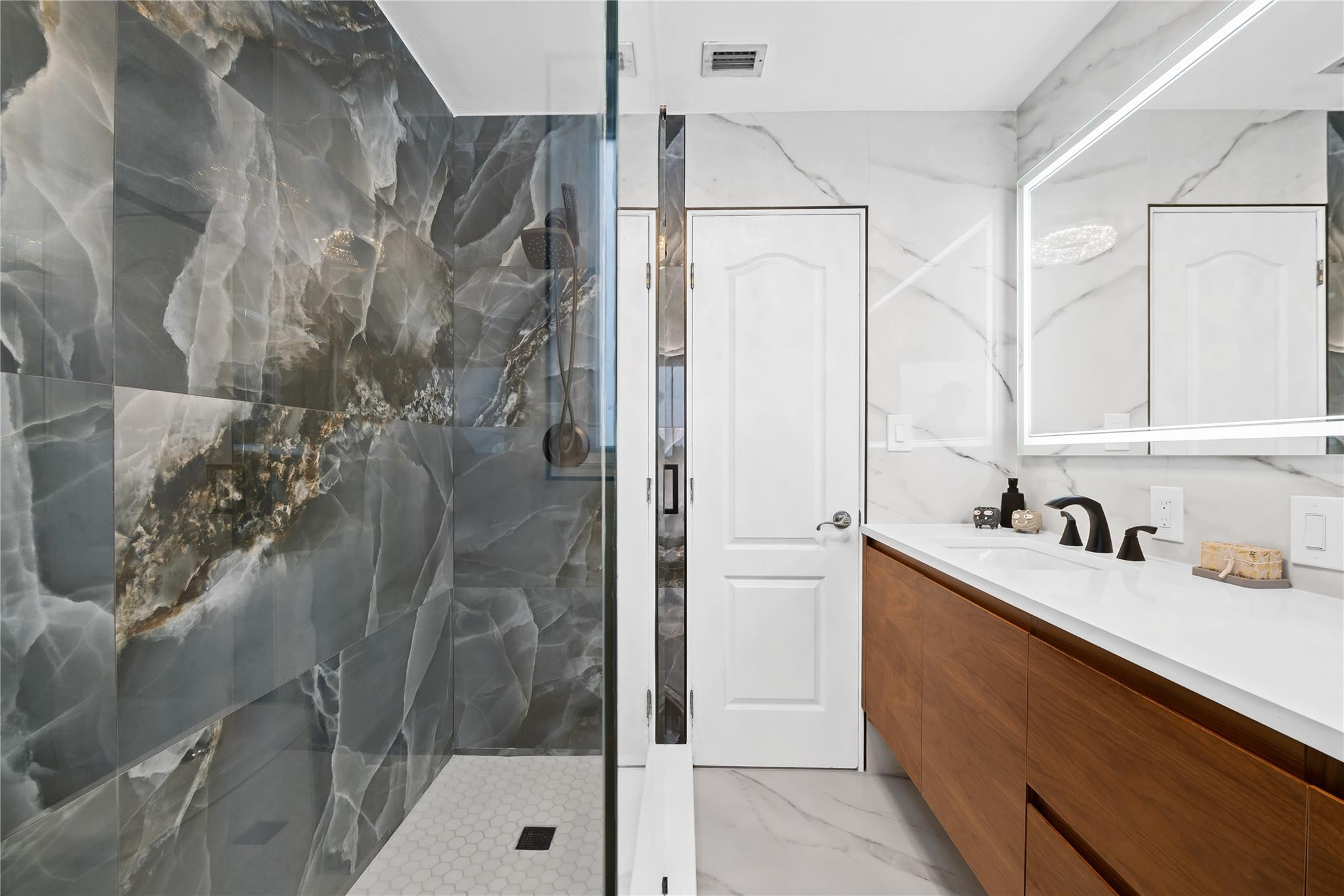 3301 Northeast 27th Avenue Lighthouse Point, FL 33064 - Photo 17 of 41 a bathroom with a sink and shower