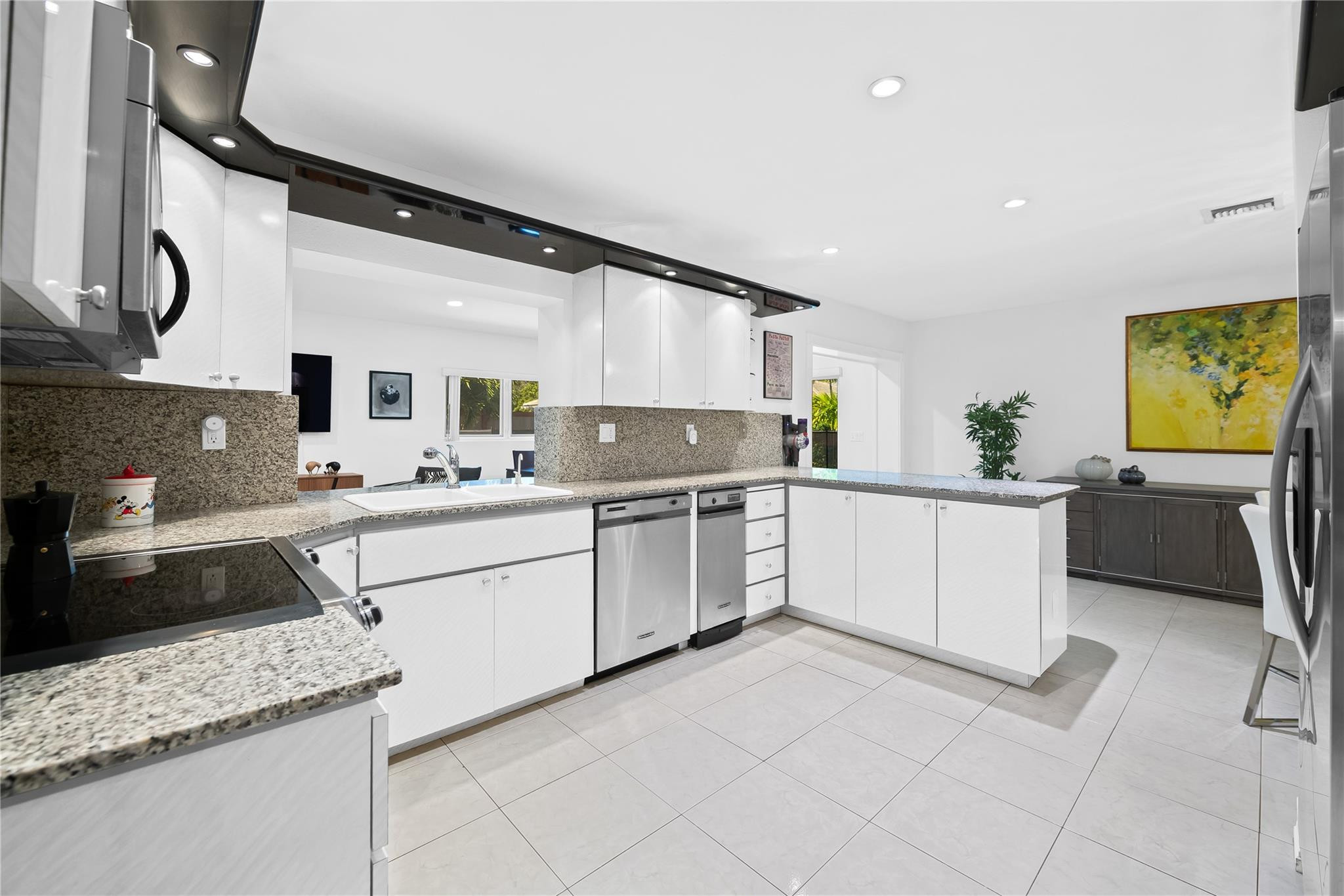 3301 Northeast 27th Avenue Lighthouse Point, FL 33064 - Photo 23 of 41 a kitchen with granite countertop a sink stainless steel appliances and cabinets