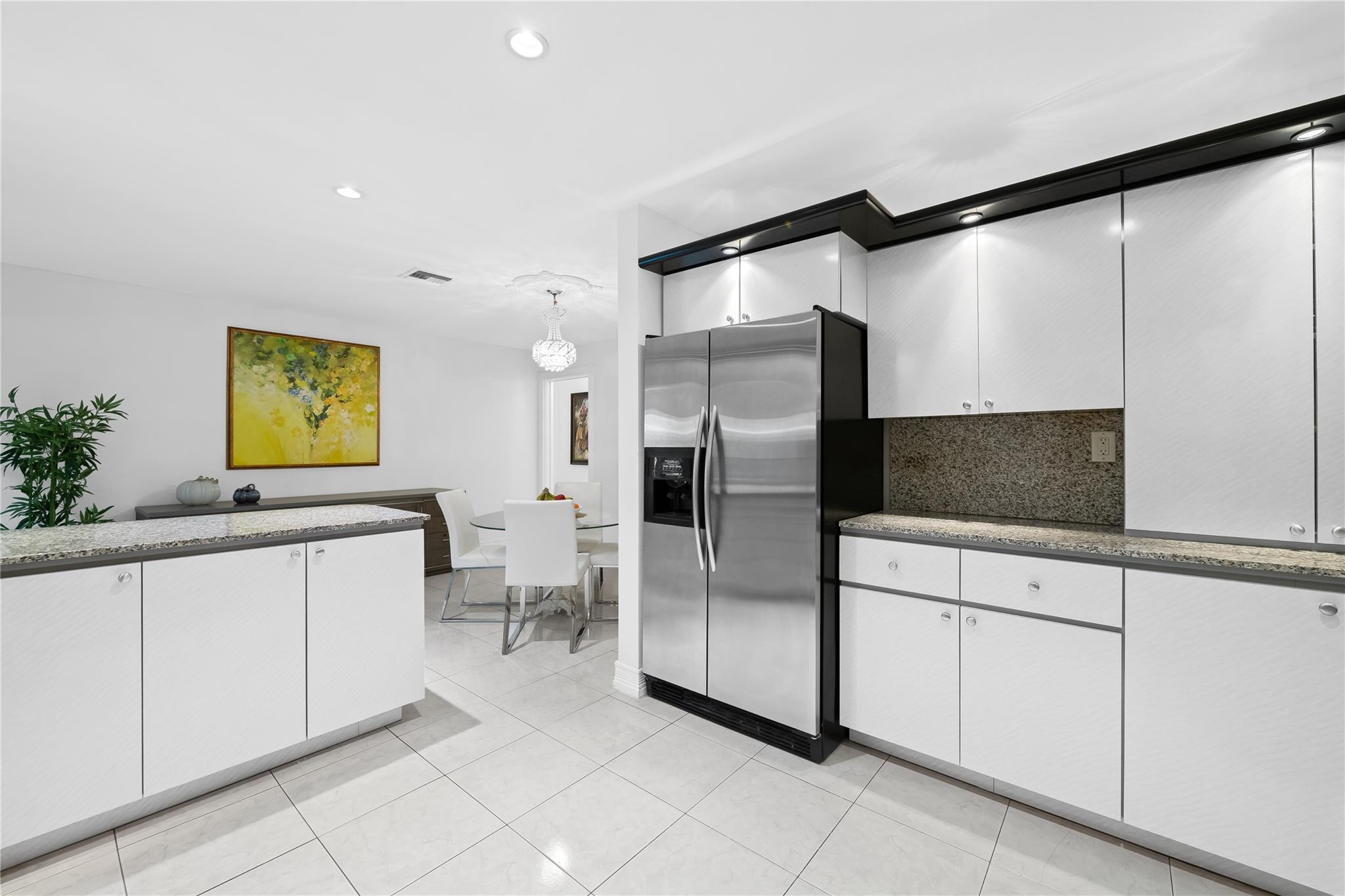 3301 Northeast 27th Avenue Lighthouse Point, FL 33064 - Photo 24 of 41 a kitchen with stainless steel appliances a refrigerator and a sink