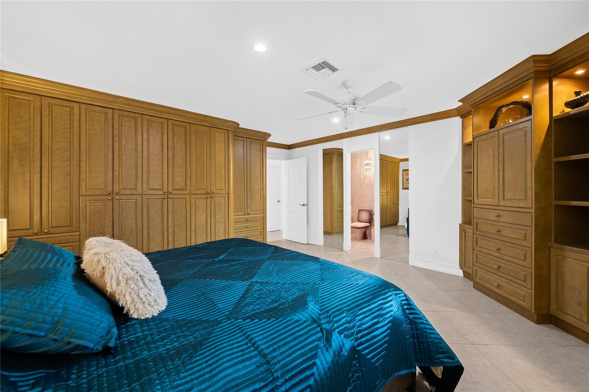 3301 Northeast 27th Avenue Lighthouse Point, FL 33064 - Photo 26 of 41 a bedroom with a bed closet and a walk in closet