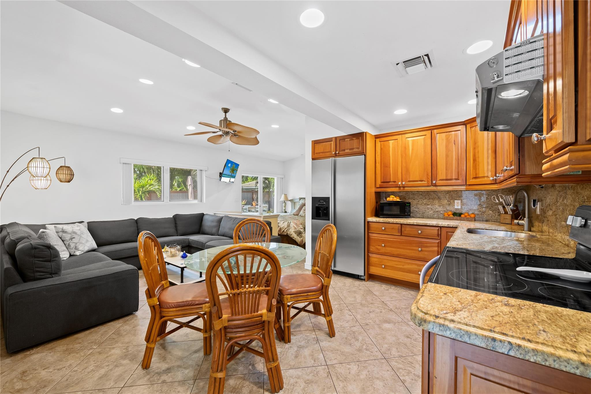 3301 Northeast 27th Avenue Lighthouse Point, FL 33064 - Photo 38 of 41 a dining room with a couch and a stove top oven