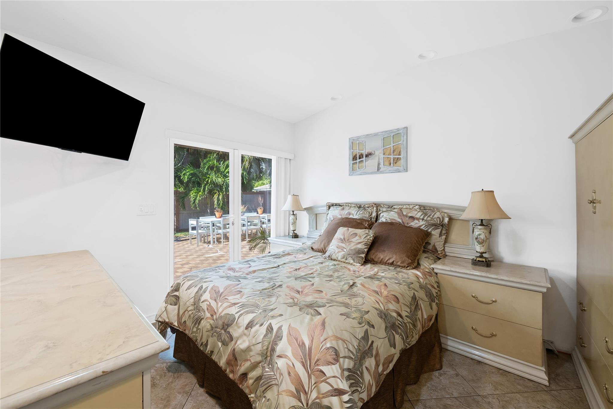 3301 Northeast 27th Avenue Lighthouse Point, FL 33064 - Photo 39 of 41 a bed sitting in a bedroom and a flat screen tv