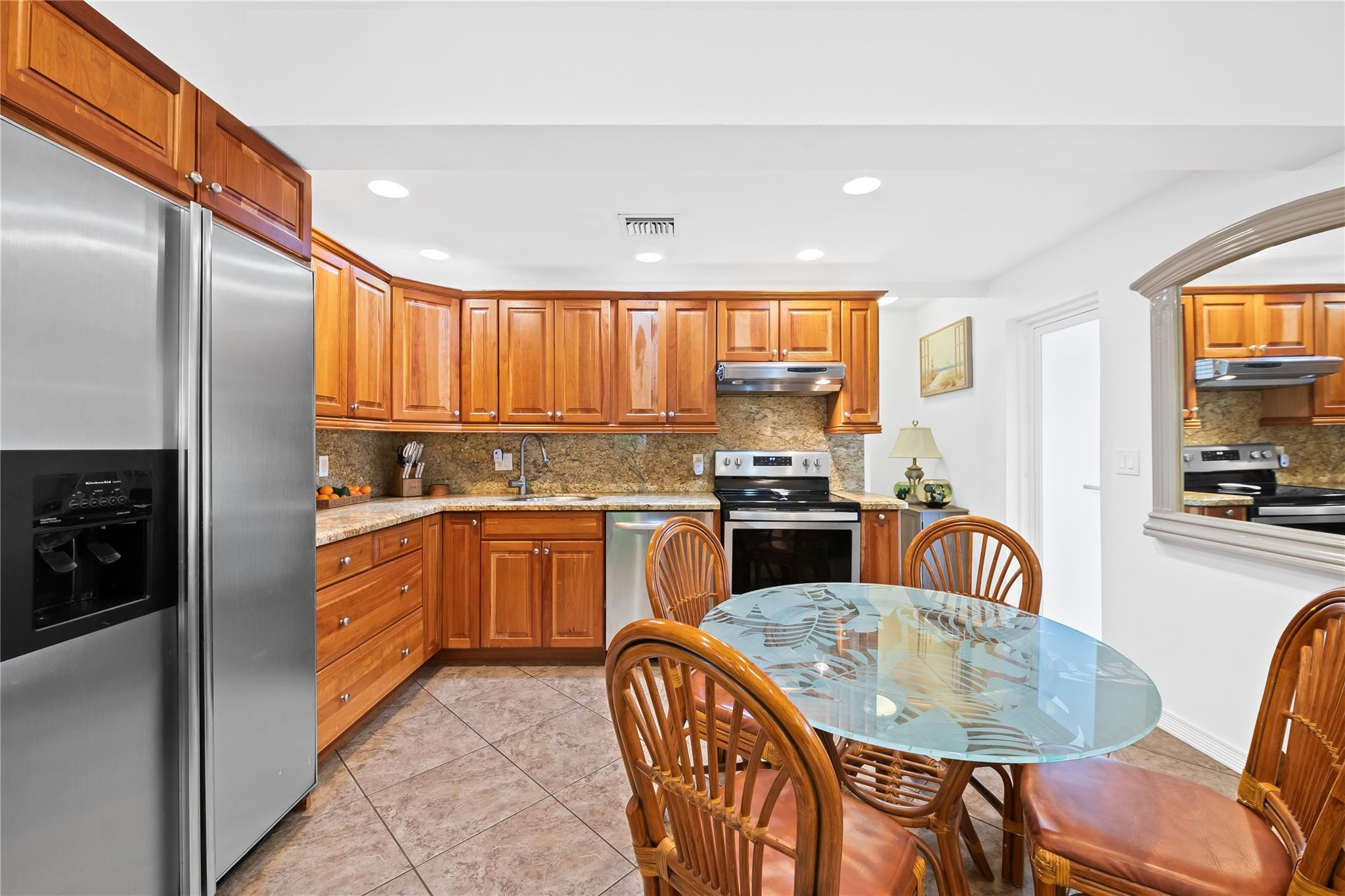 3301 Northeast 27th Avenue Lighthouse Point, FL 33064 - Photo 41 of 41 a kitchen with stainless steel appliances granite countertop a kitchen island a stove a table and chairs