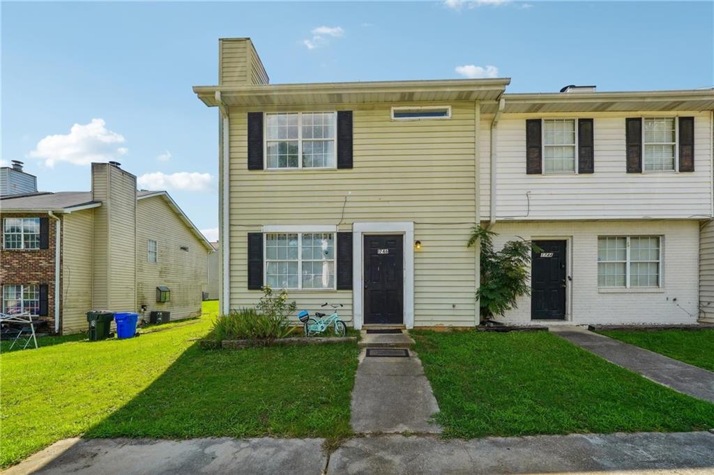 1746 Ridge Court Southeast Conyers, GA 30013 - Photo 1 of 1 a front view of a house with a garden and plants