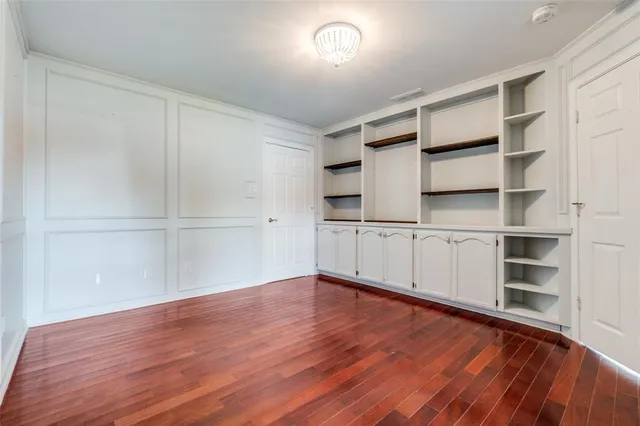 a view of a room with wooden floor and closet
