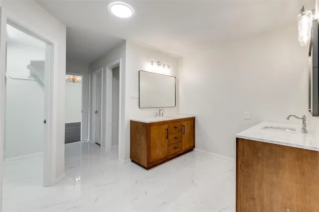 a bathroom with a tub sink and mirror