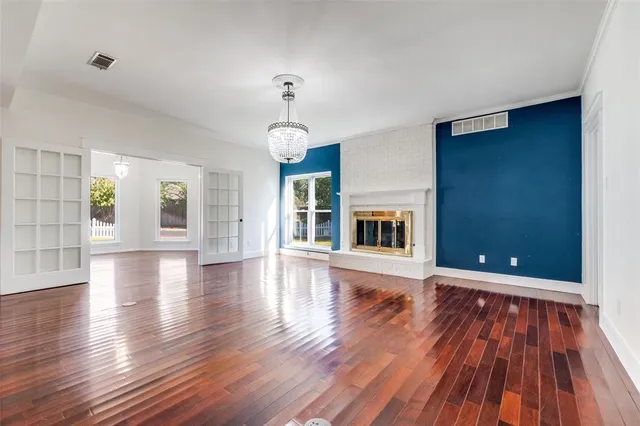 a view of a room with wooden floors and fireplace