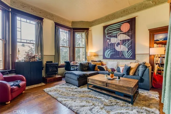 a living room with furniture and a floor to ceiling window