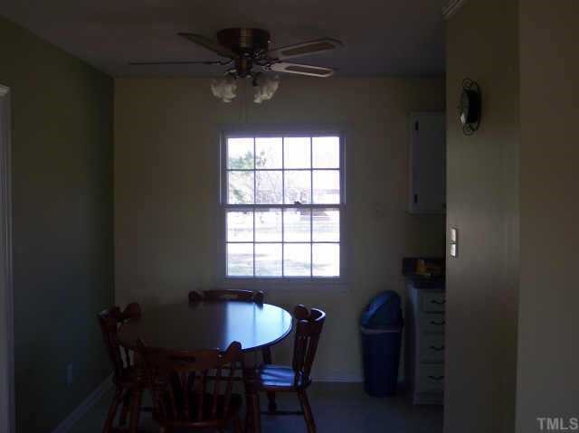 1109 Ridge Haven Drive Wendell, NC 27591 - Photo 4 of 5 a dining room with a table chairs and a chandelier