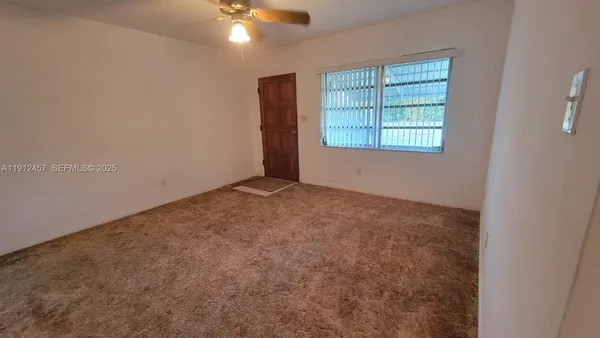 an empty room with windows and closet
