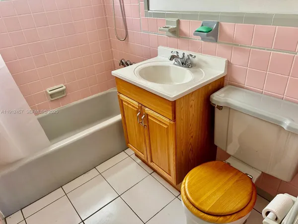 a bathroom with a sink a toilet and bathtub