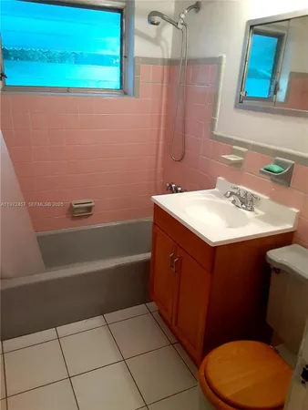a bathroom with a sink a toilet and bathtub