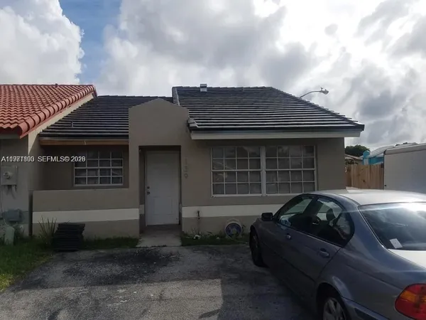 a front view of a house with parking space