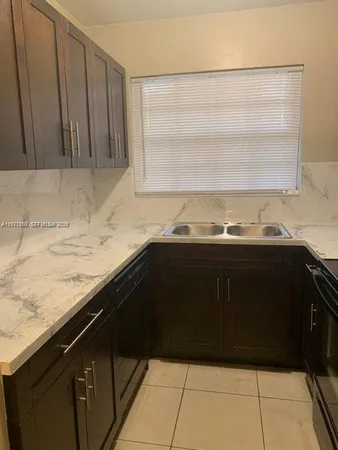 a kitchen with granite countertop cabinets and a sink