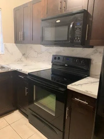 a stove top oven sitting inside of a kitchen