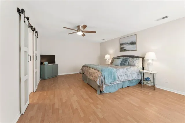 a bedroom with a large bed and a chandelier