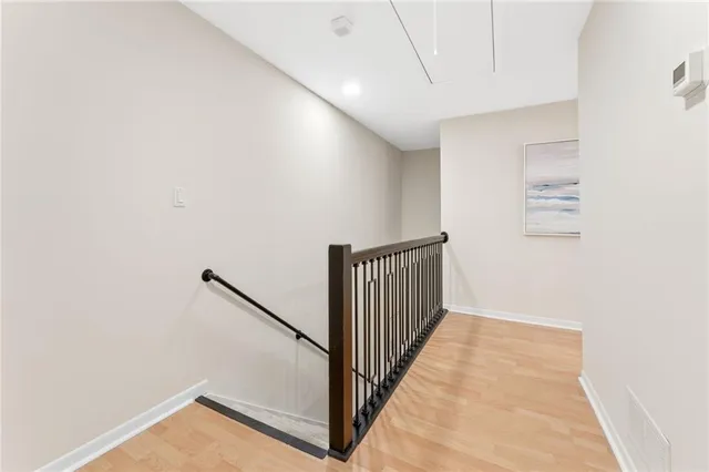 a view of a hallway with wooden floor
