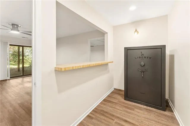 a view of a hallway with wooden floor