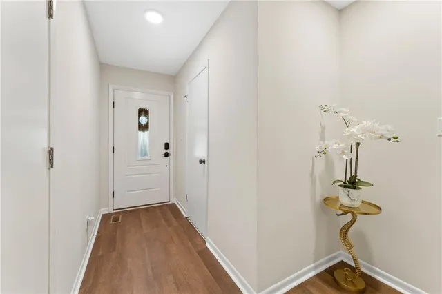 a view of a room with wooden floor