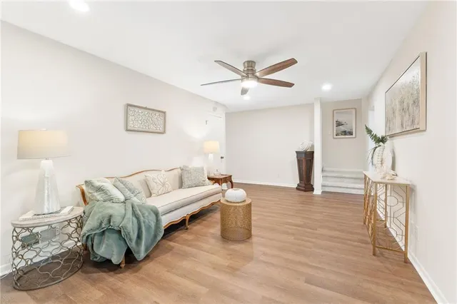 a living room with furniture and a wooden floor
