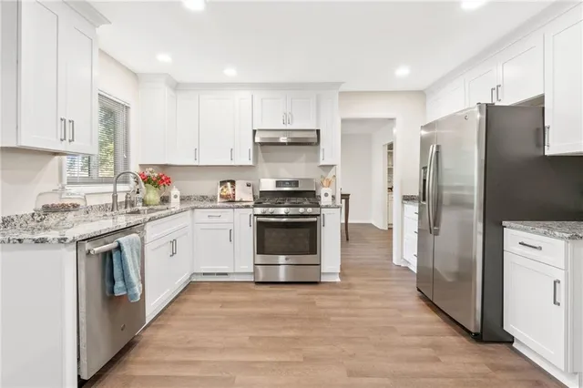 a kitchen with a refrigerator stove and sink