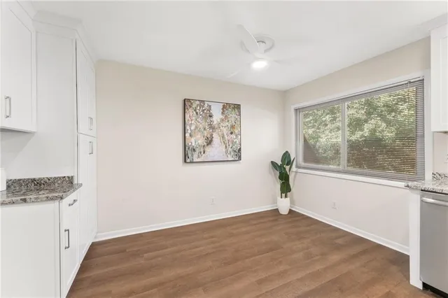 a view of a room with wooden floor and window
