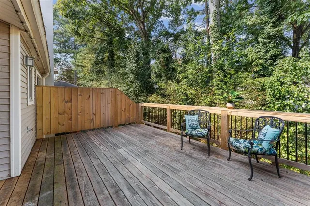 a balcony with wooden floor and outdoor space