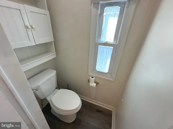 a white toilet sitting next to a window