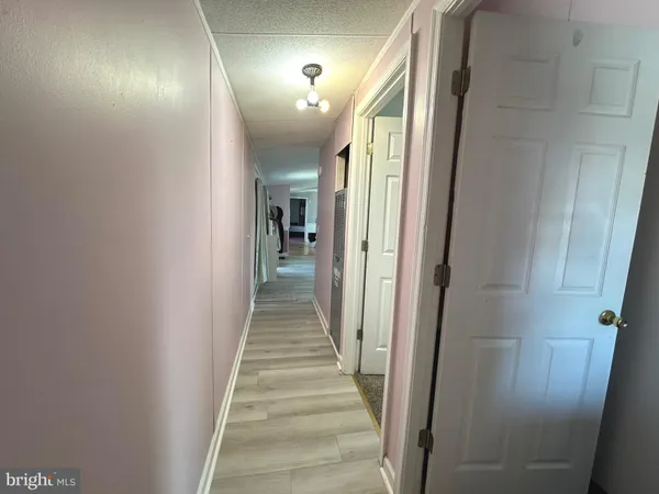 a view of a hallway with the wooden floor