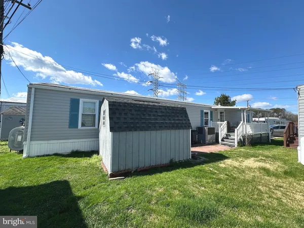 a view of a backyard with a garden and entertaining space