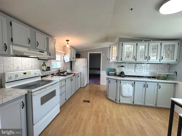 a kitchen with stainless steel appliances granite countertop a stove and cabinets