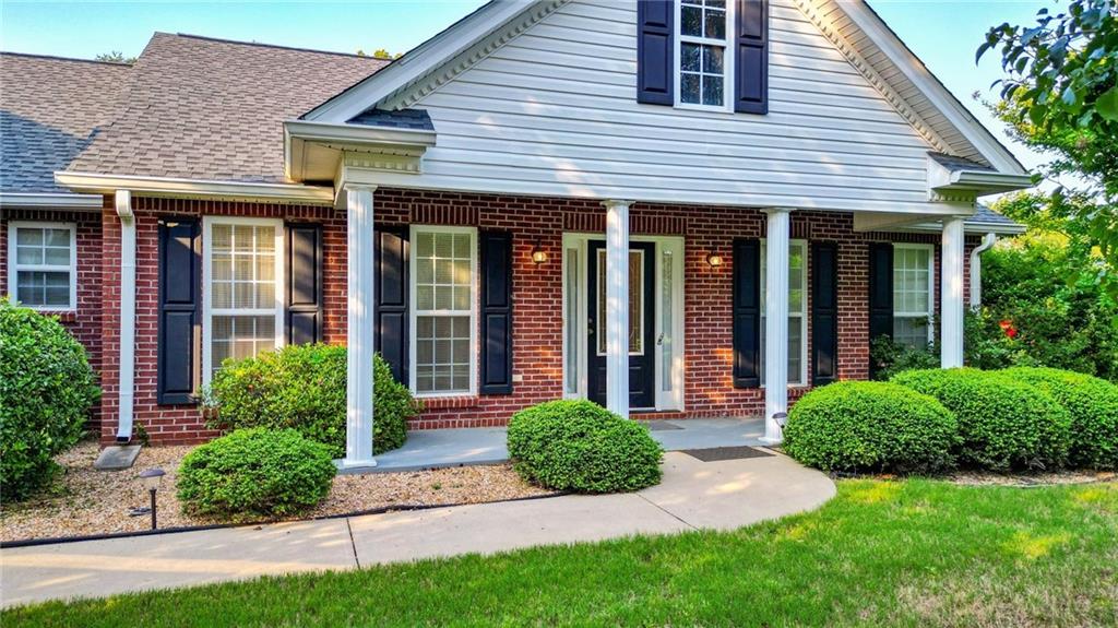 80 Stringer Road Rockmart, GA 30153 - Photo 1 of 1 a view of a house with brick walls plants and large tree
